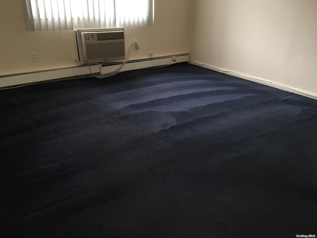 spare room featuring a wall mounted AC, plenty of natural light, and carpet