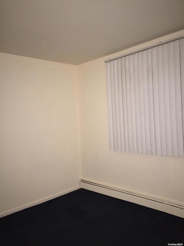 empty room with a baseboard heating unit