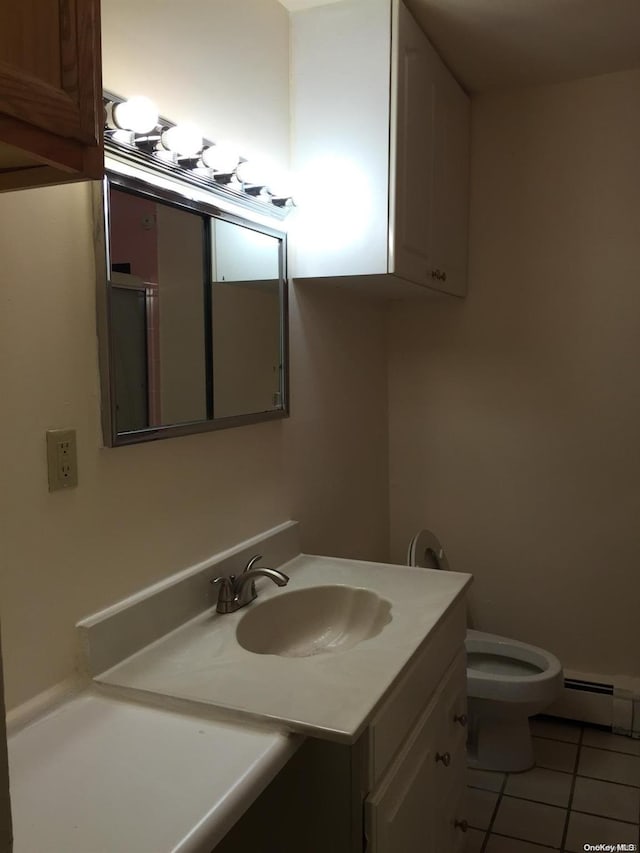 bathroom with tile patterned flooring, vanity, a baseboard radiator, and toilet