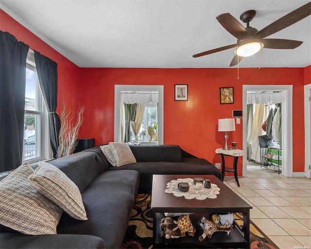 tiled living room featuring ceiling fan and a wealth of natural light