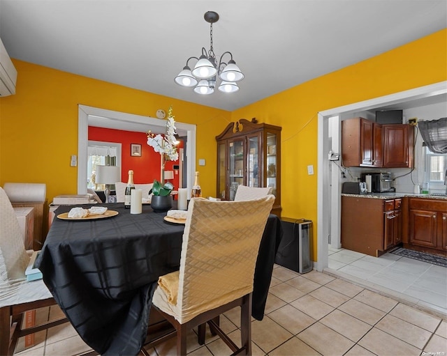 tiled dining space with a chandelier