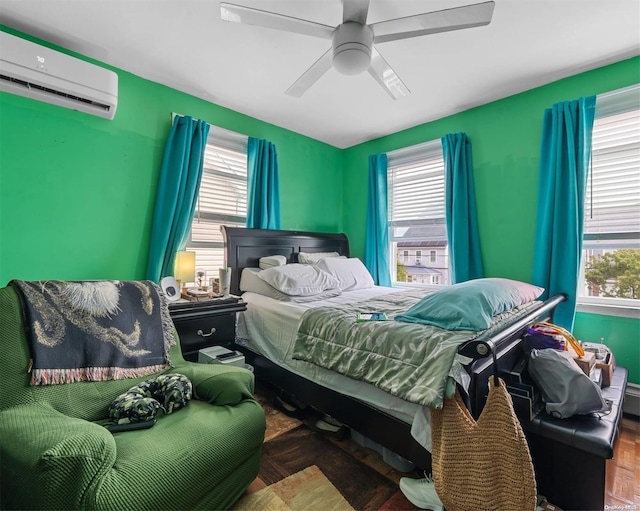 bedroom with a wall unit AC and ceiling fan