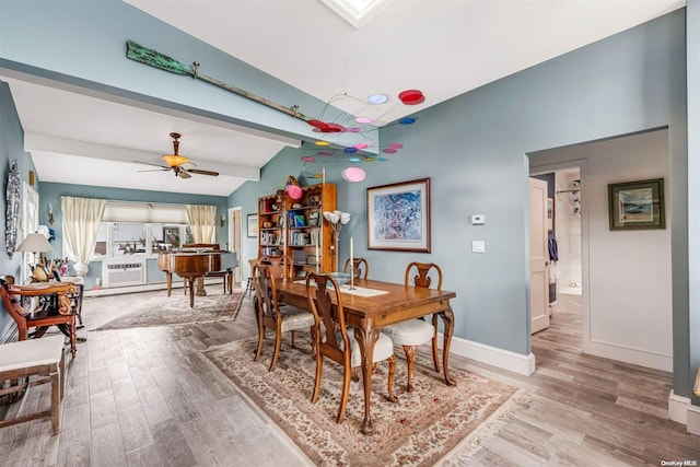 dining room featuring hardwood / wood-style floors, lofted ceiling with beams, and ceiling fan