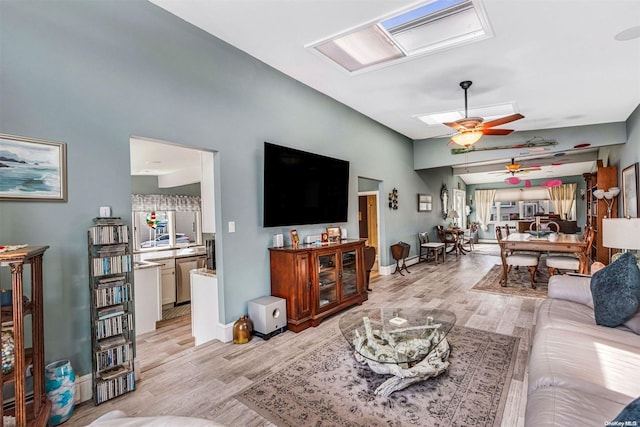 living room featuring light hardwood / wood-style floors and ceiling fan