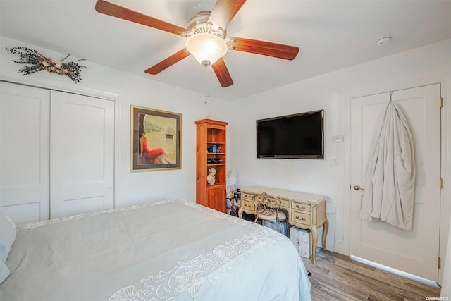 bedroom featuring light wood-type flooring, a closet, and ceiling fan