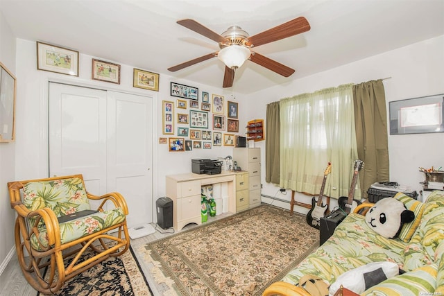 living room featuring ceiling fan and light hardwood / wood-style floors