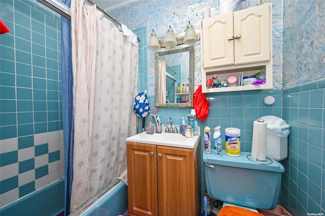 full bathroom featuring vanity, shower / bath combination with curtain, tile walls, and toilet