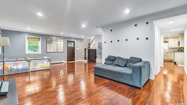 living room with crown molding, light hardwood / wood-style flooring, and baseboard heating