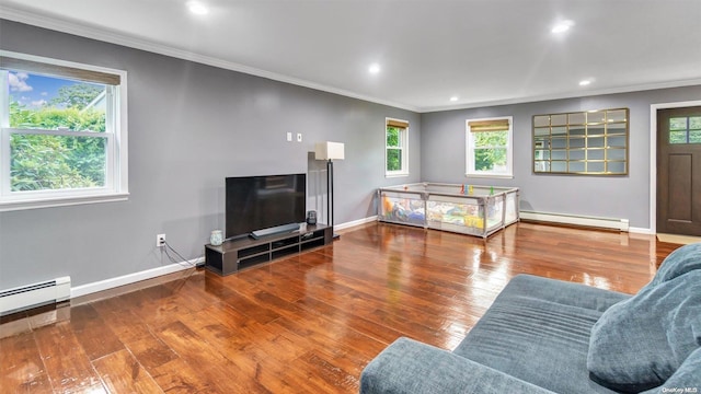 living room featuring hardwood / wood-style flooring, ornamental molding, and baseboard heating