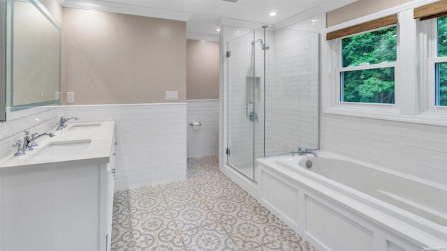 bathroom featuring shower with separate bathtub, tile walls, tile patterned flooring, vanity, and crown molding