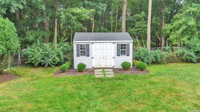 view of outbuilding featuring a lawn