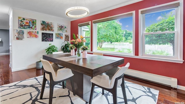 dining space featuring ornamental molding, dark hardwood / wood-style floors, and baseboard heating