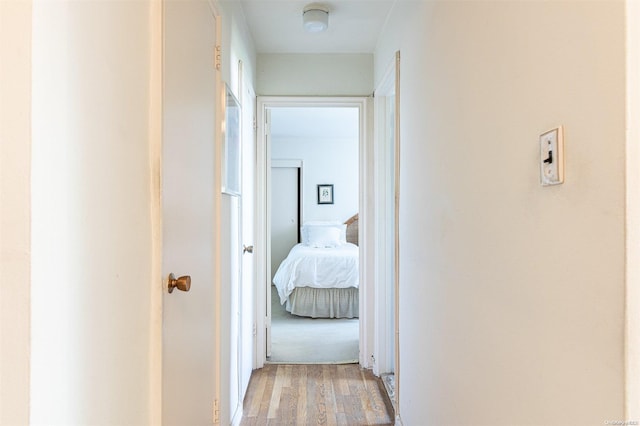 hallway with light hardwood / wood-style floors