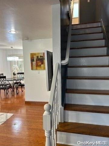 staircase with wood-type flooring