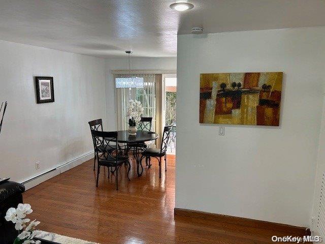 dining room featuring dark hardwood / wood-style flooring and an inviting chandelier