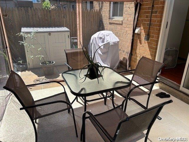 view of patio / terrace with a storage unit and area for grilling