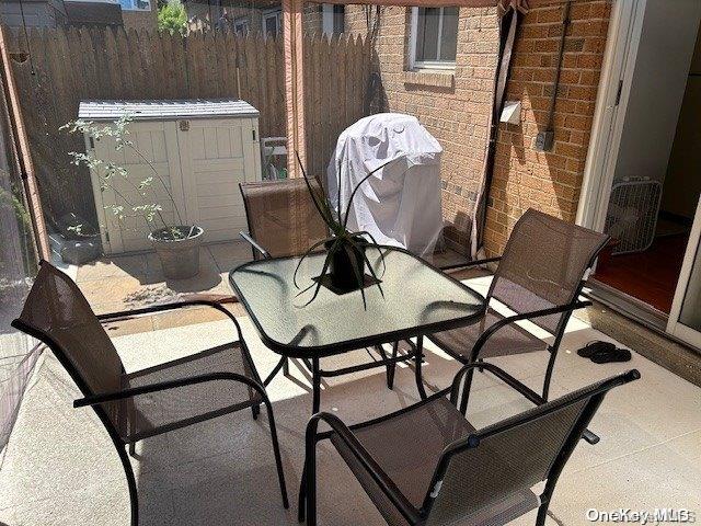 920 Broadway Unit 15, Woodmere, NY 11598 - balcony featuring a grill and outdoor dining area