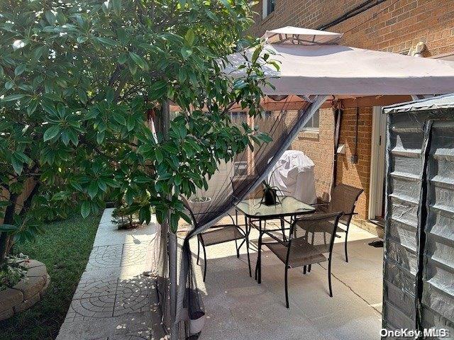 920 Broadway Unit 15, Woodmere, NY 11598 - view of patio featuring a gazebo and outdoor dining space