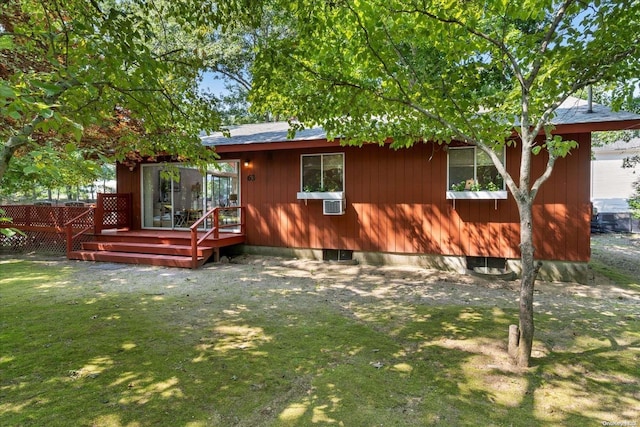 back of house featuring a wooden deck and a lawn