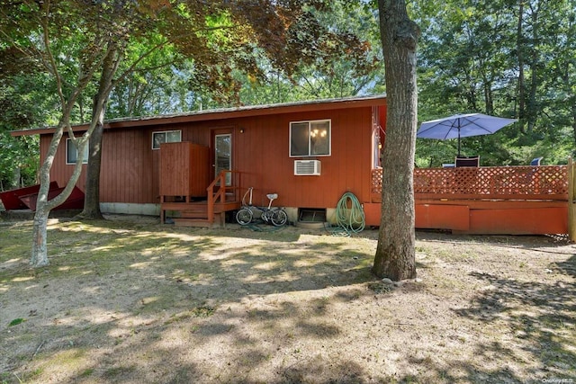 back of property with a wooden deck