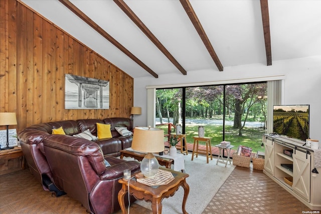 living room with wood walls, beamed ceiling, a healthy amount of sunlight, and high vaulted ceiling