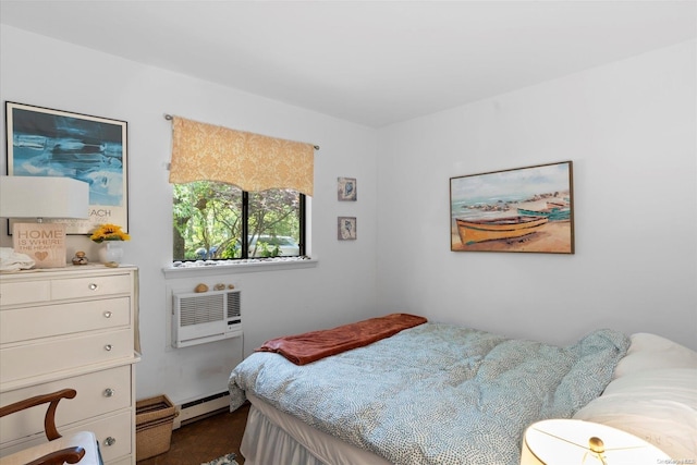 bedroom featuring dark colored carpet, a wall unit AC, and a baseboard heating unit