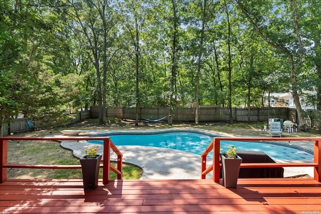 view of swimming pool with a deck, a diving board, and a patio area