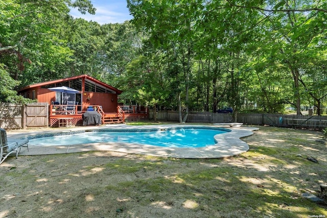 view of pool with a diving board and a deck