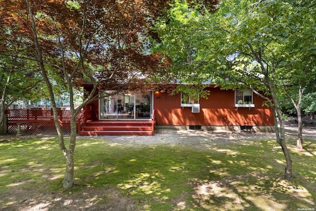 rear view of property with cooling unit and a lawn