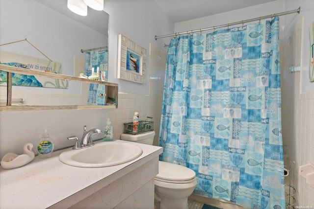 bathroom with a shower with shower curtain, vanity, toilet, and tile walls