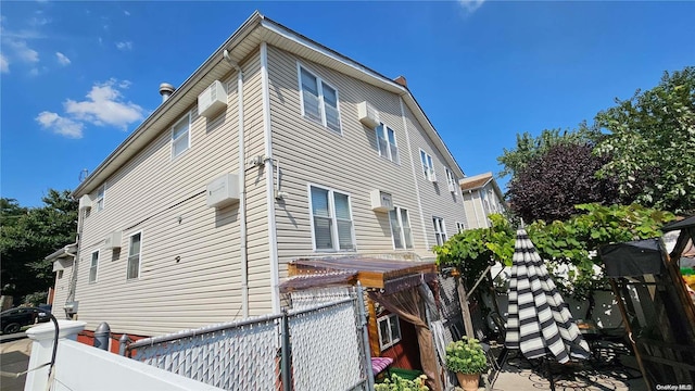 view of home's exterior with an AC wall unit