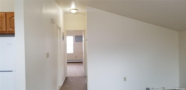 corridor with lofted ceiling, a baseboard radiator, and light colored carpet