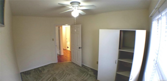 unfurnished bedroom featuring dark hardwood / wood-style flooring and ceiling fan