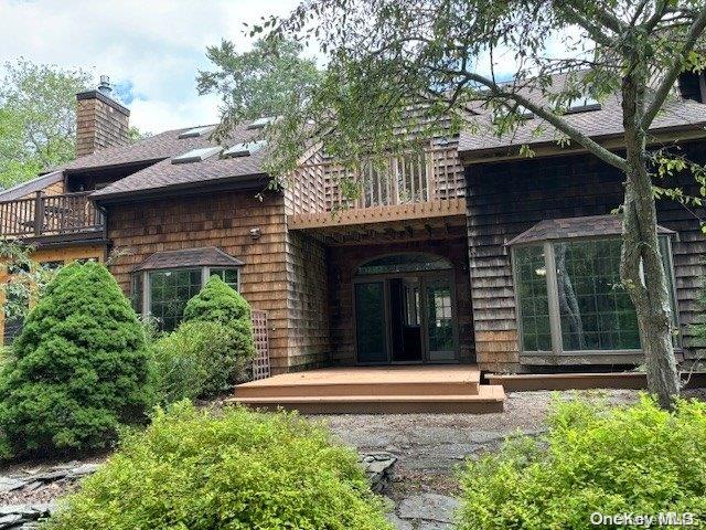 back of house featuring a balcony