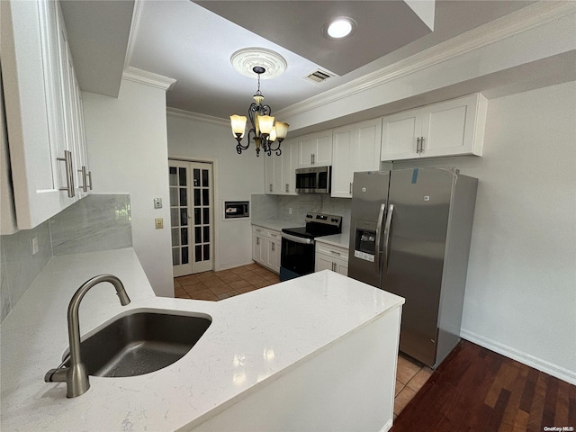 kitchen with white cabinetry, sink, appliances with stainless steel finishes, and ornamental molding