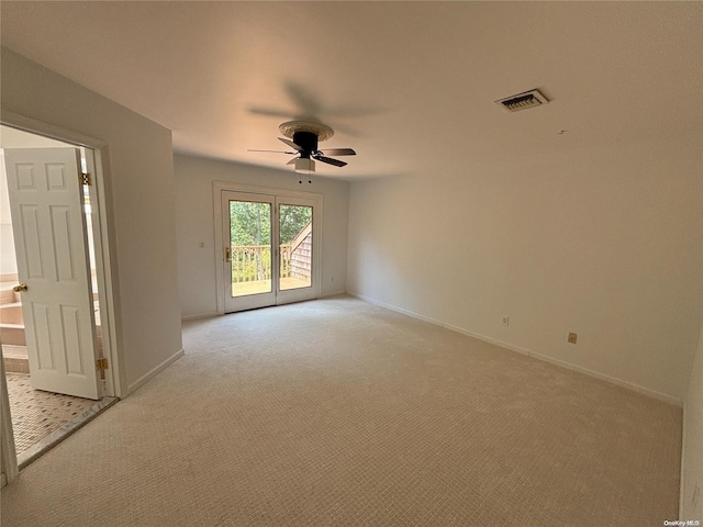 unfurnished room featuring ceiling fan and light carpet