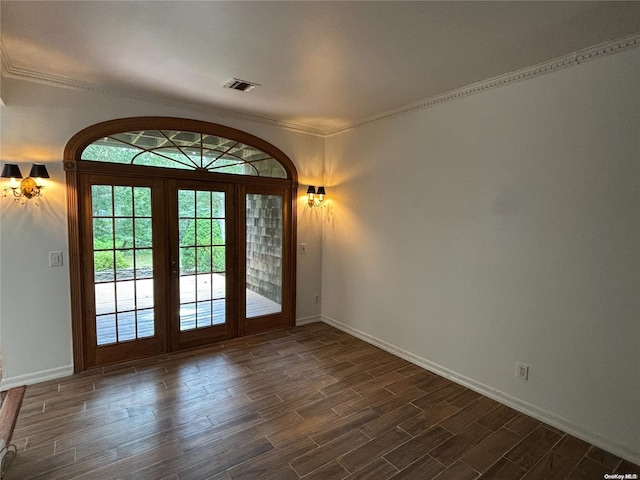 doorway with dark hardwood / wood-style flooring, french doors, and ornamental molding