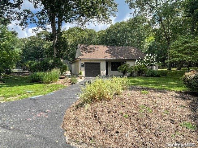 view of front of house with a front yard and a garage