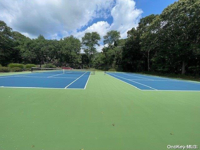 view of tennis court featuring basketball hoop