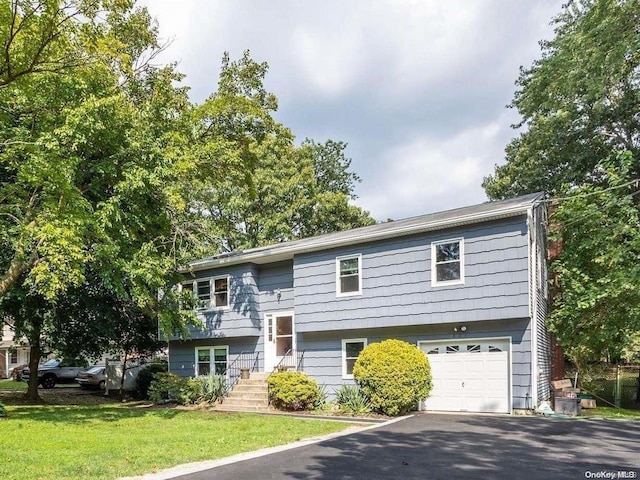 split foyer home with a front yard and a garage