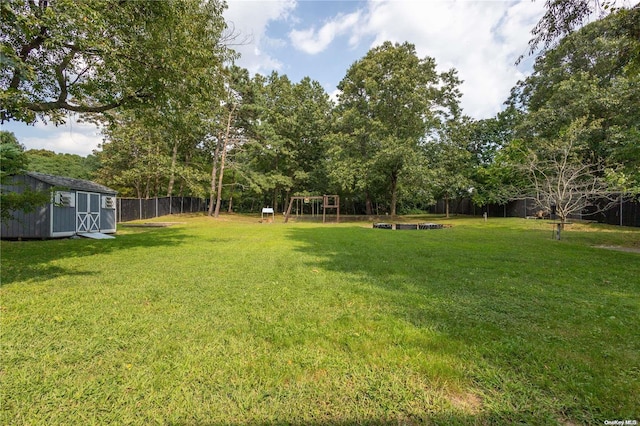 view of yard with a playground and a storage shed