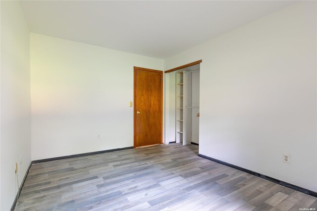 empty room with light hardwood / wood-style flooring