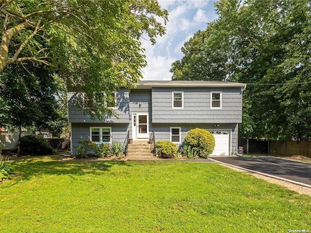 split foyer home with a front lawn and a garage