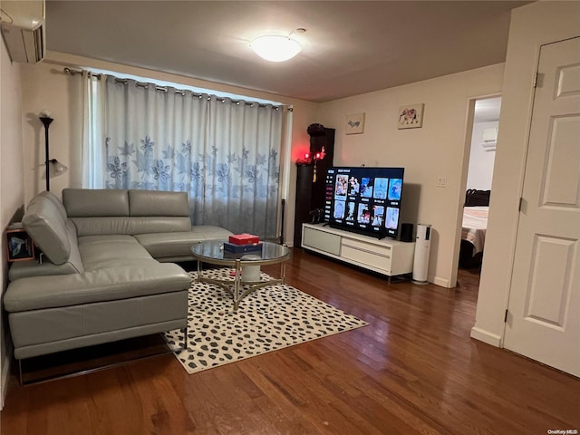 living room with a wall mounted AC and dark hardwood / wood-style flooring