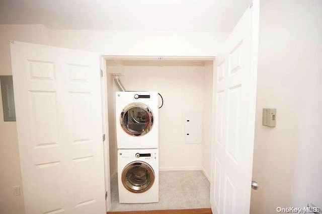 laundry area with stacked washer and clothes dryer