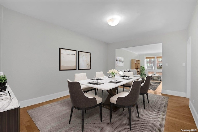 dining space with hardwood / wood-style flooring