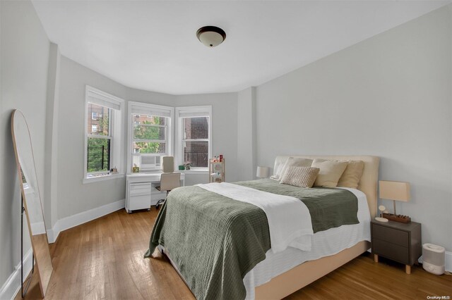 bedroom with hardwood / wood-style floors