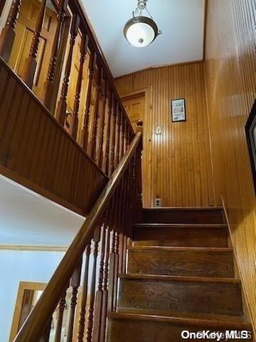 staircase with wood walls