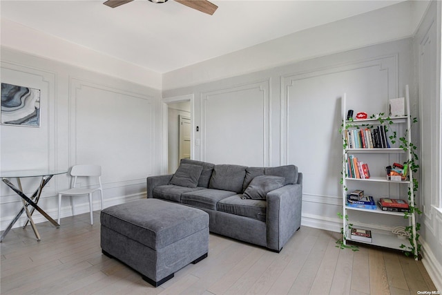 living room with ceiling fan and light hardwood / wood-style floors