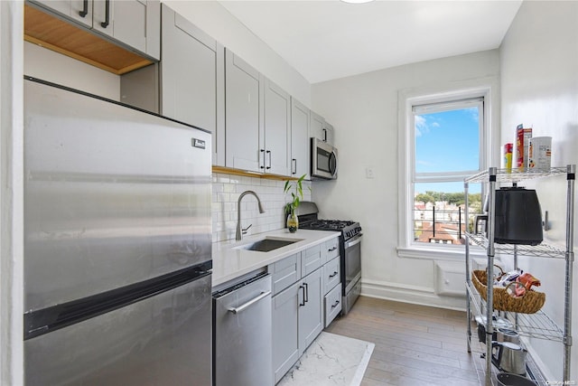 kitchen with gray cabinetry, plenty of natural light, sink, and appliances with stainless steel finishes